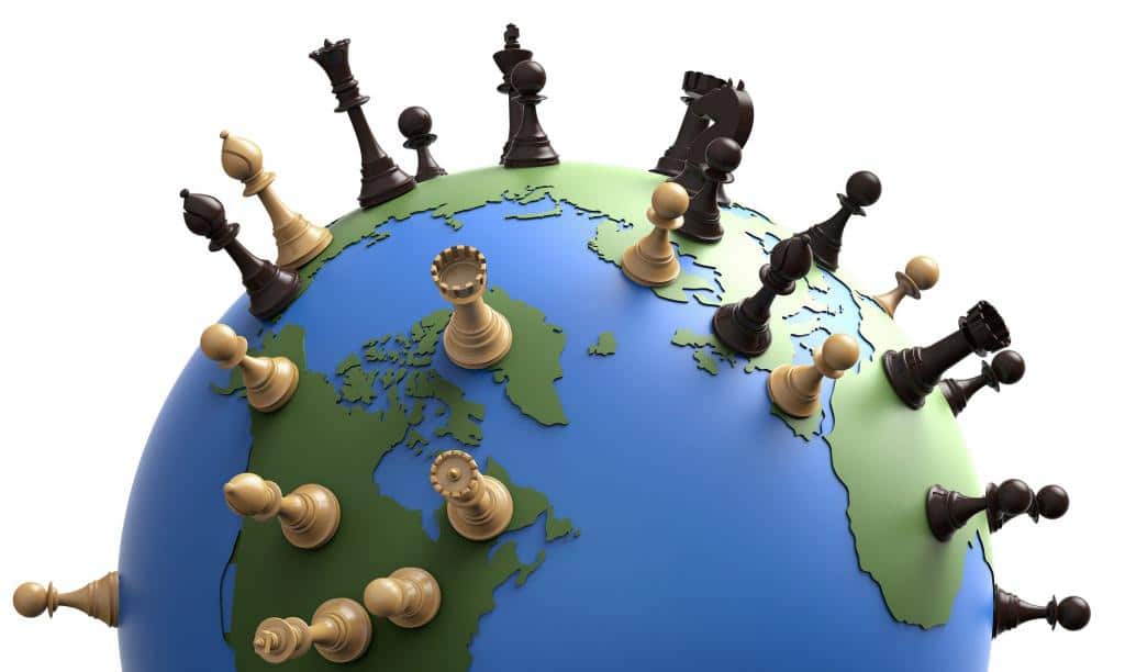 A globe with chess pieces on it

Description automatically generated